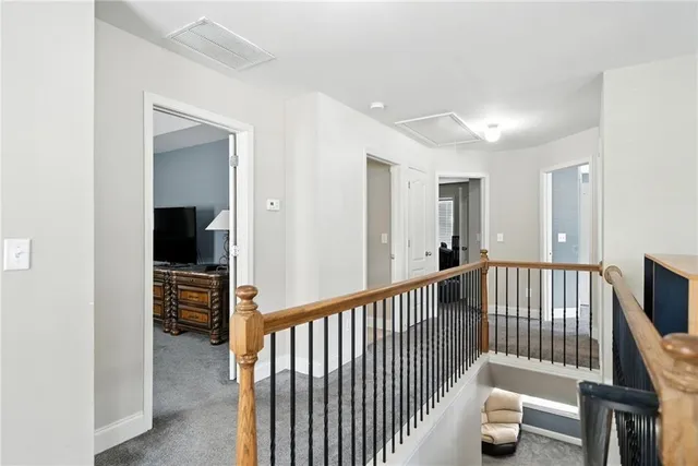 a view of a hallway with bedroom and stairs