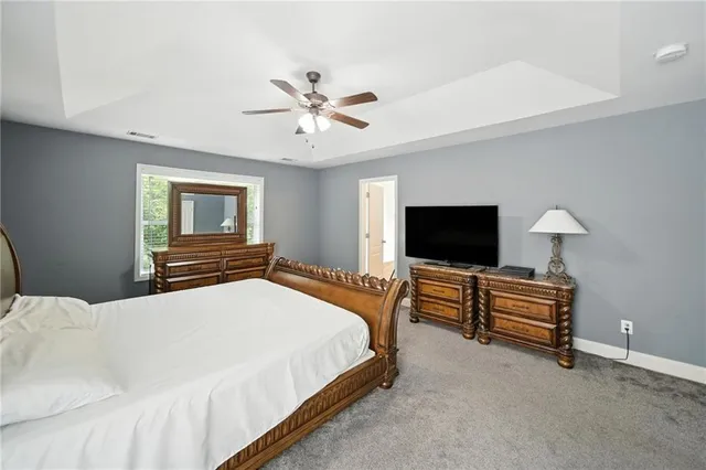 a bedroom with a bed and a television