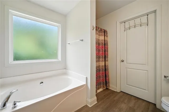 a bathroom with a bathtub and a shower