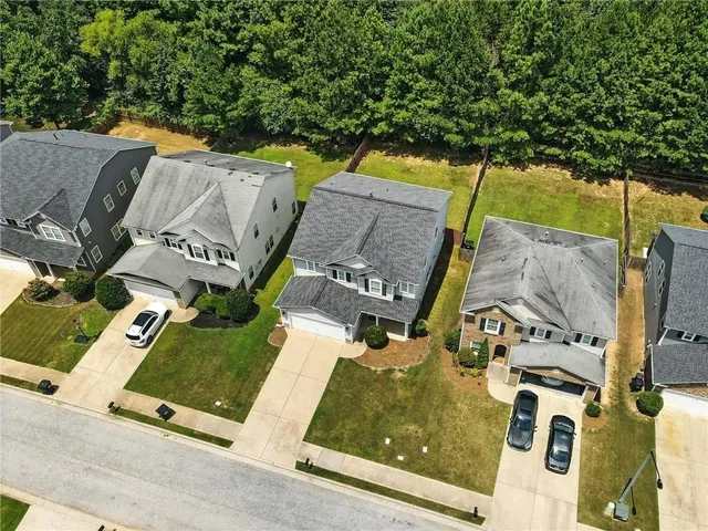 an aerial view of residential house with outdoor space and parking