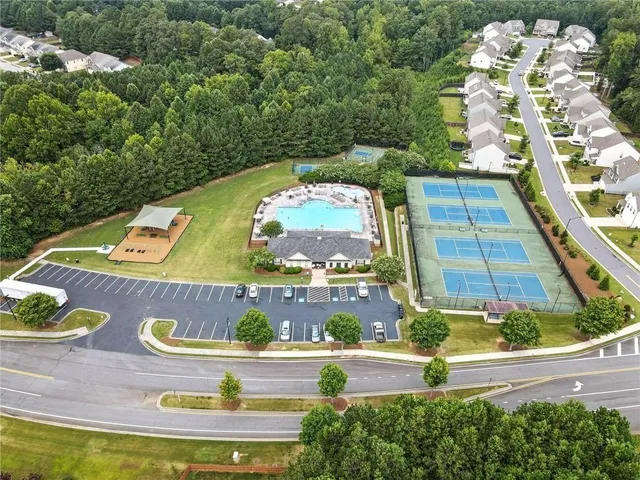 an aerial view of a house with yard swimming pool and outdoor seating
