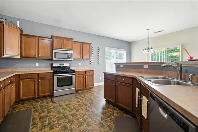 a kitchen with a sink stove and microwave