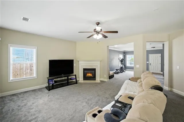 a living room with furniture a fireplace and a flat screen tv