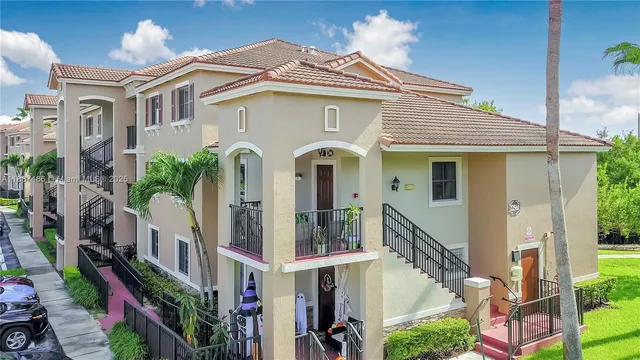 a front view of a house with a lots of windows and plants