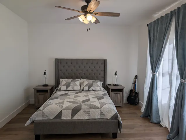 a bedroom with a bed and a chandelier