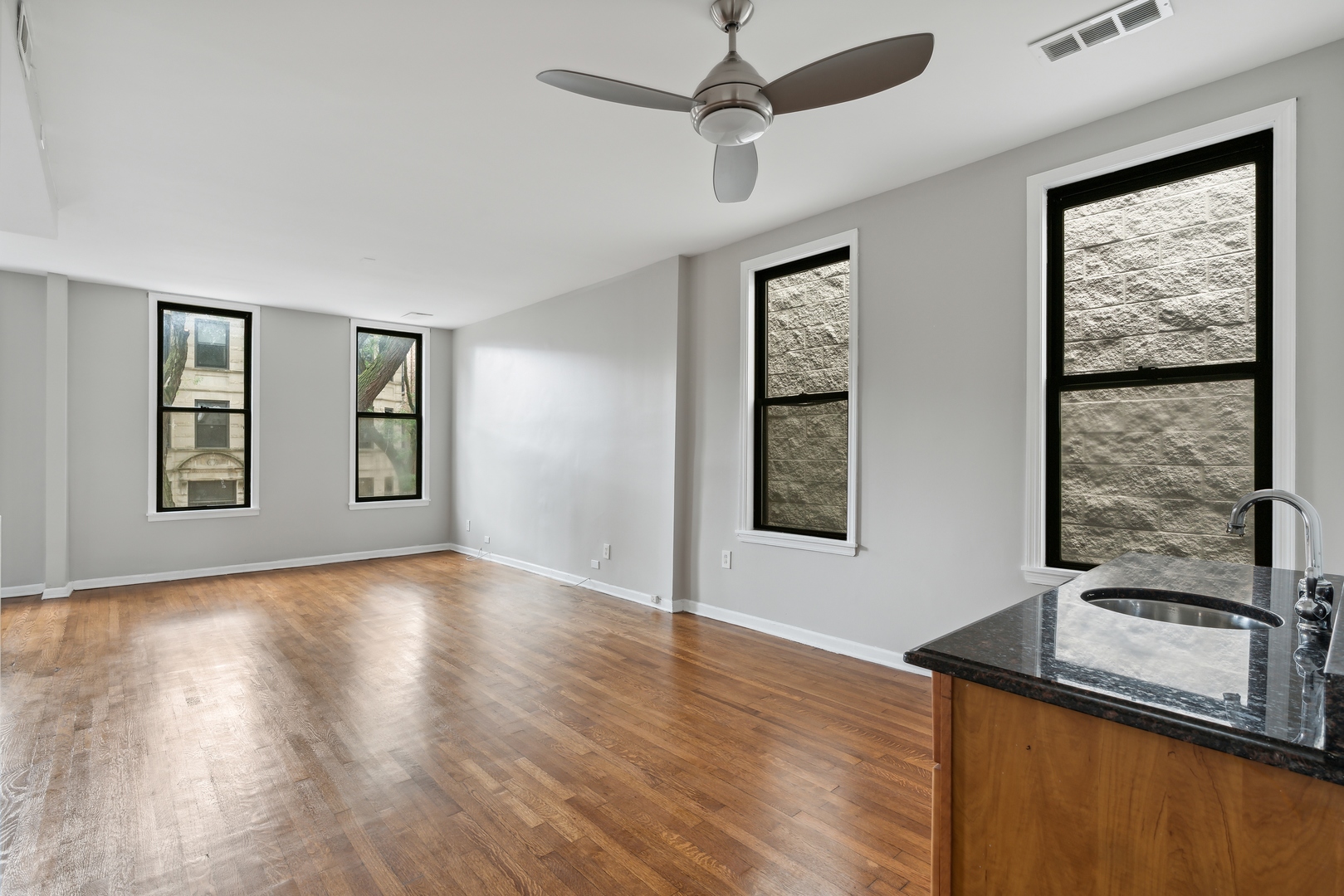 1439 West Lexington Street Chicago, IL 60607 - Photo 11 of 22 wooden floor in an empty room with a window
