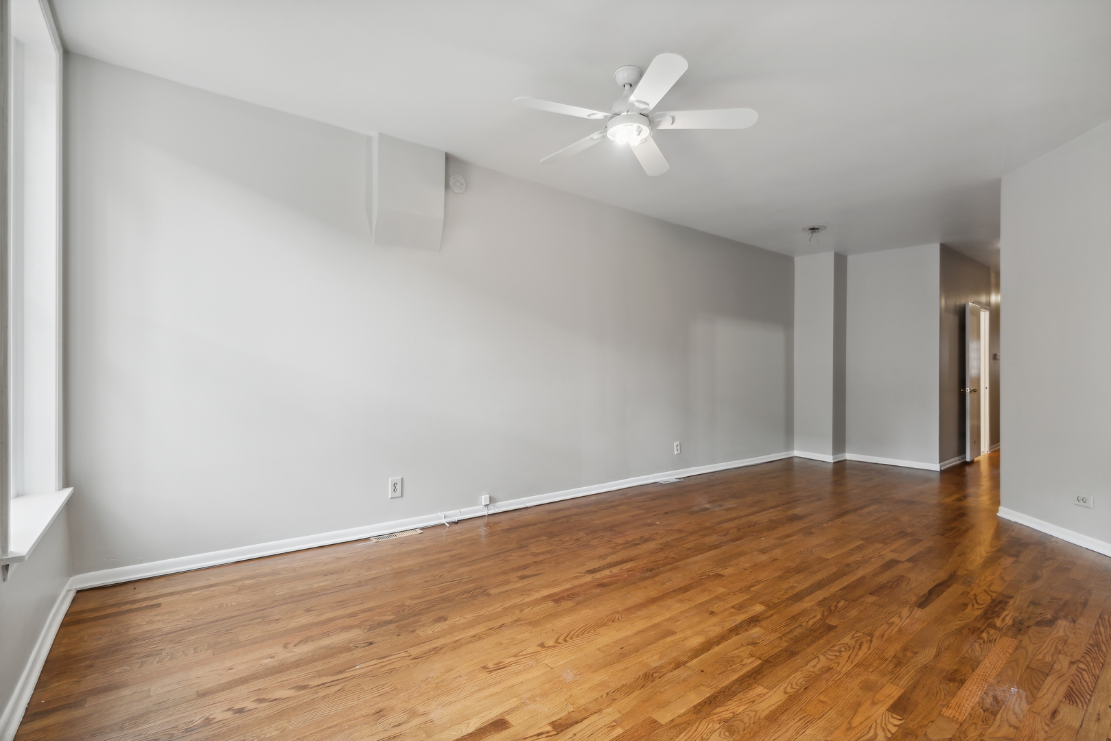 1439 West Lexington Street Chicago, IL 60607 - Photo 2 of 22 a view of an empty room with wooden floor