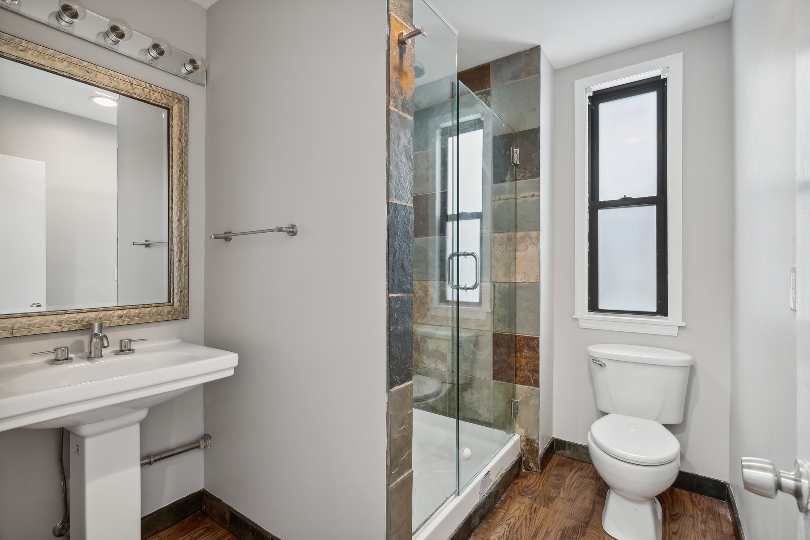 1439 West Lexington Street Chicago, IL 60607 - Photo 22 of 22 a bathroom with a sink toilet and shower