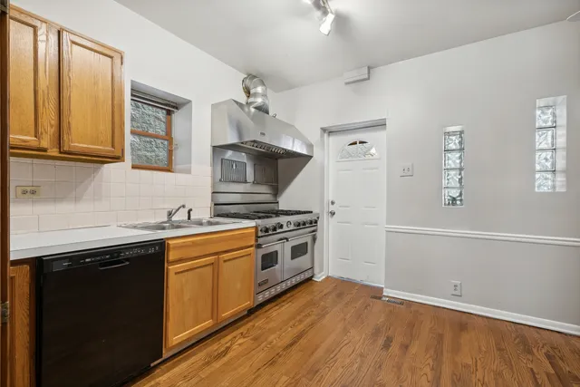 a kitchen with a sink stove and cabinets