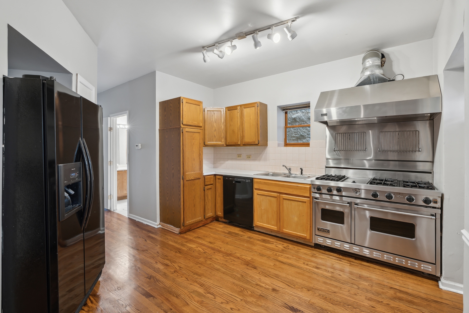 1439 West Lexington Street Chicago, IL 60607 - Photo 6 of 22 a kitchen with stainless steel appliances granite countertop a stove a refrigerator and a refrigerator