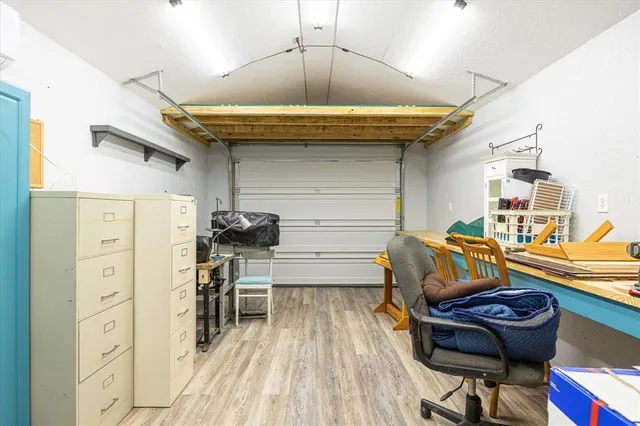 a view of a workspace with furniture and gym equipment
