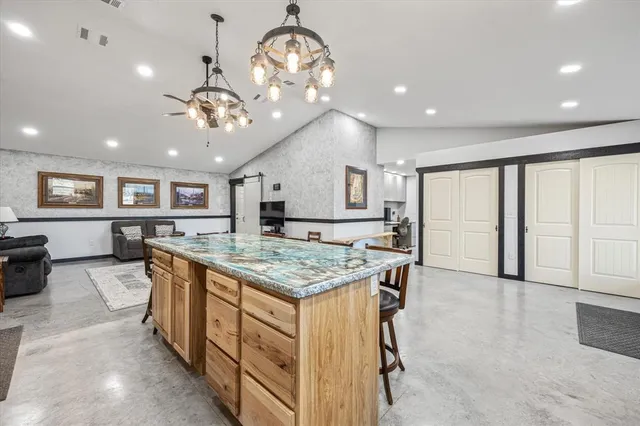 a large kitchen with kitchen island a large island in the center
