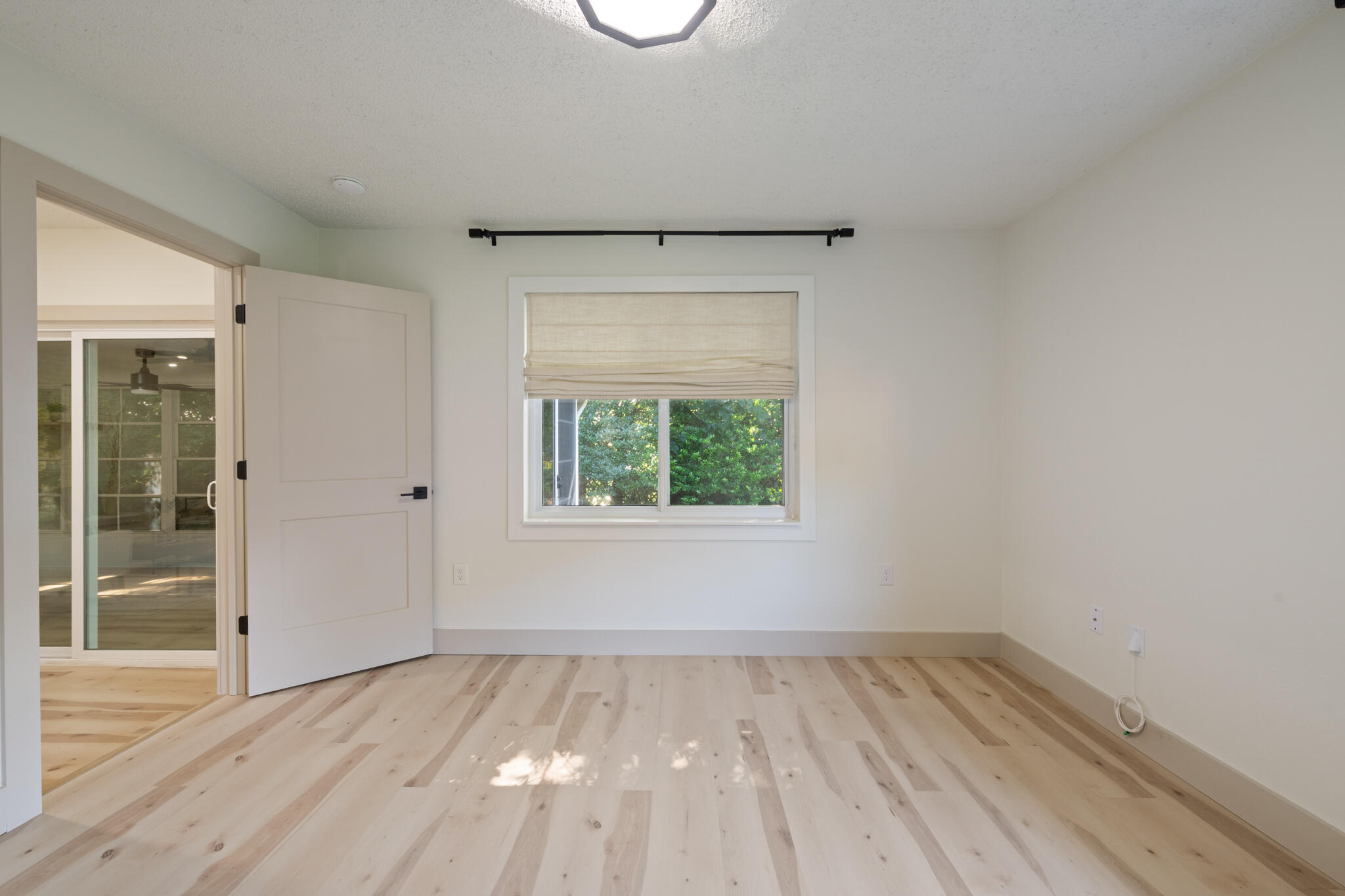 538 22nd Street Niceville, FL 32578 - Photo 36 of 46 an empty room with a window and wooden floor