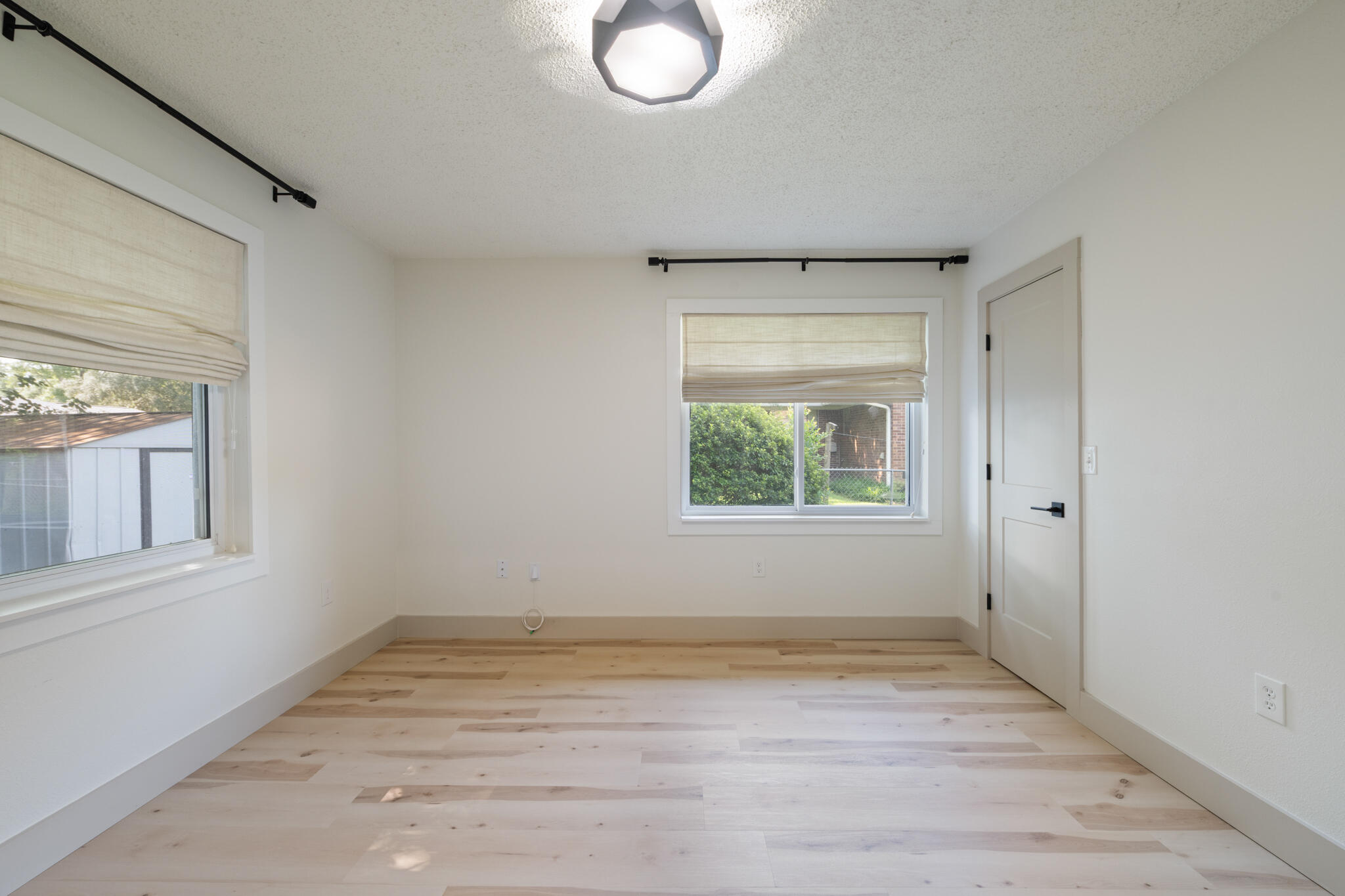 538 22nd Street Niceville, FL 32578 - Photo 37 of 46 an empty room with wooden floor and windows