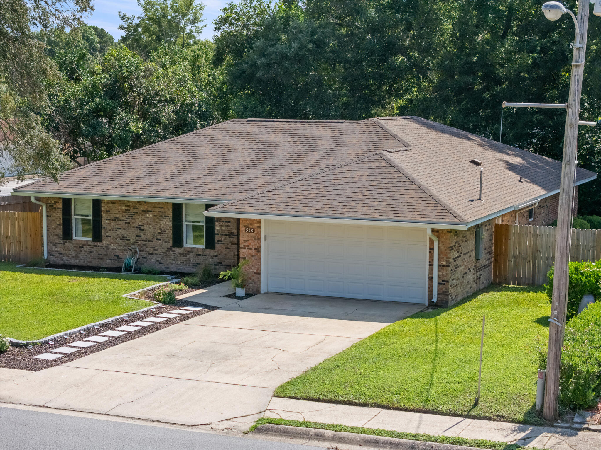 538 22nd Street Niceville, FL 32578 - Photo 5 of 46 a view of a house with a yard plants and large tree