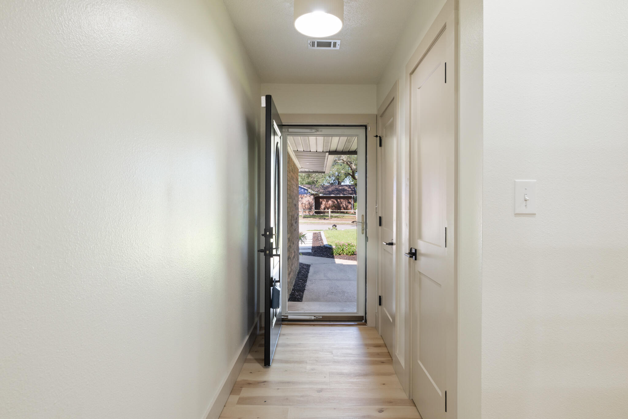 538 22nd Street Niceville, FL 32578 - Photo 7 of 46 a view of a hallway with wooden floor and a bathroom