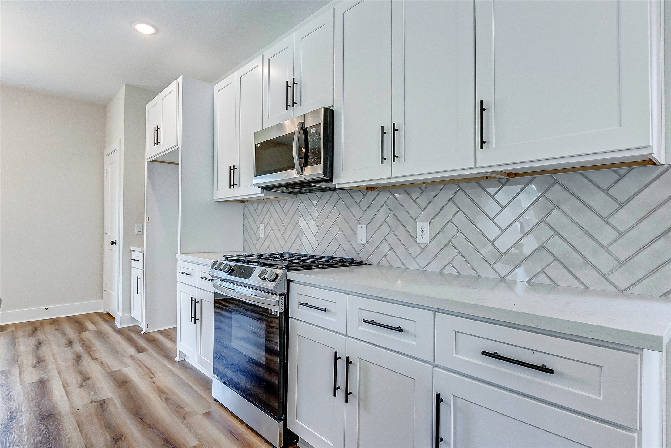 5407 Lee Street Houston, TX 77020 - Photo 13 of 36 a kitchen with white cabinets and appliances