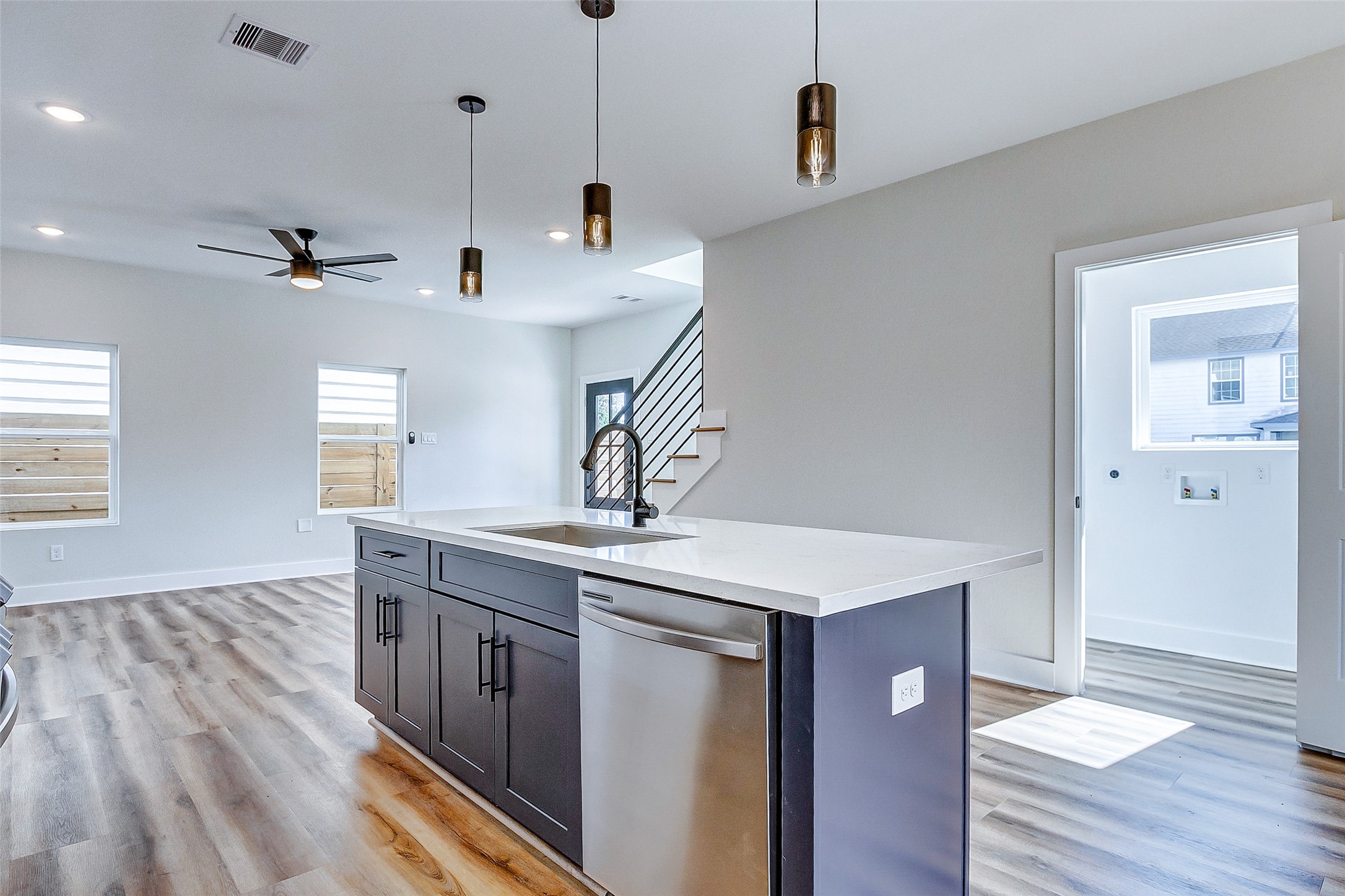 5407 Lee Street Houston, TX 77020 - Photo 14 of 36 a kitchen with stainless steel appliances granite countertop a sink a stove and a wooden floor