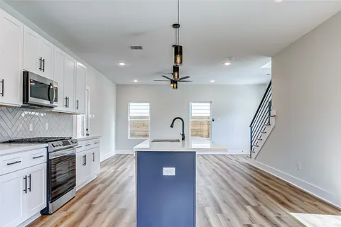a view of kitchen with sink microwave and stove