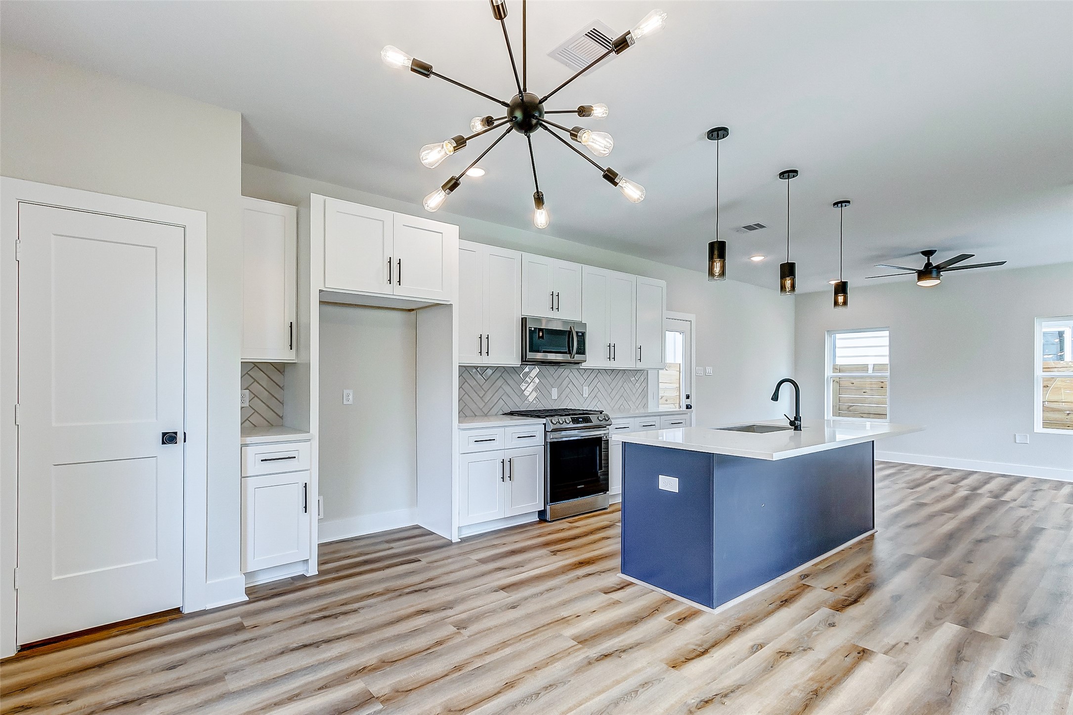 5407 Lee Street Houston, TX 77020 - Photo 16 of 36 a large kitchen with stainless steel appliances kitchen island granite countertop a refrigerator and a stove top oven