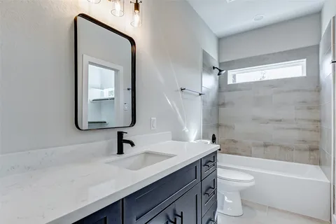 a bathroom with a sink a toilet and a bathtub