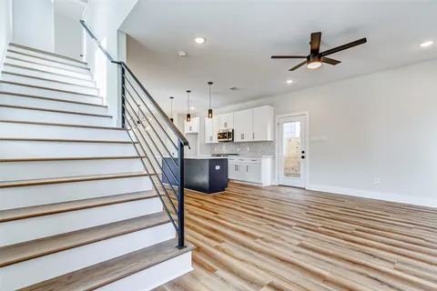 a view of a kitchen with sink and stainless steel appliances