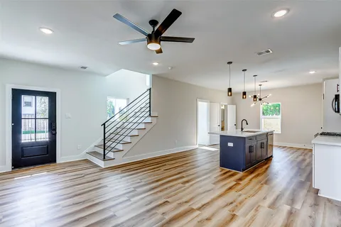 a view of kitchen and hall with wooden floor