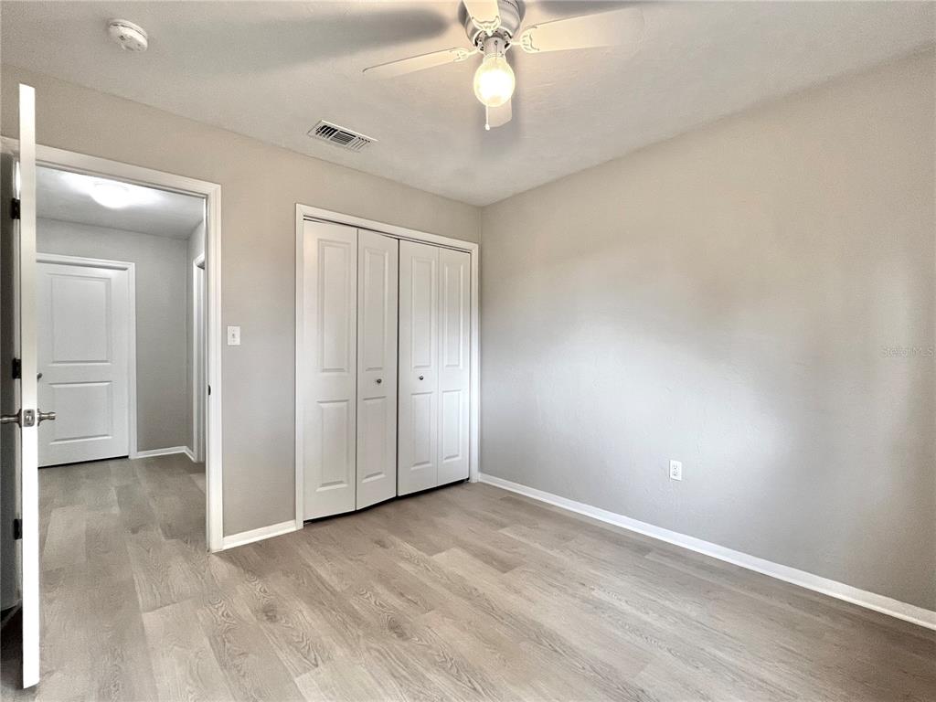 507 Northwest 39th Road, Unit 312 Gainesville, FL 32607 - Photo 19 of 34 an empty room with fan and entrance