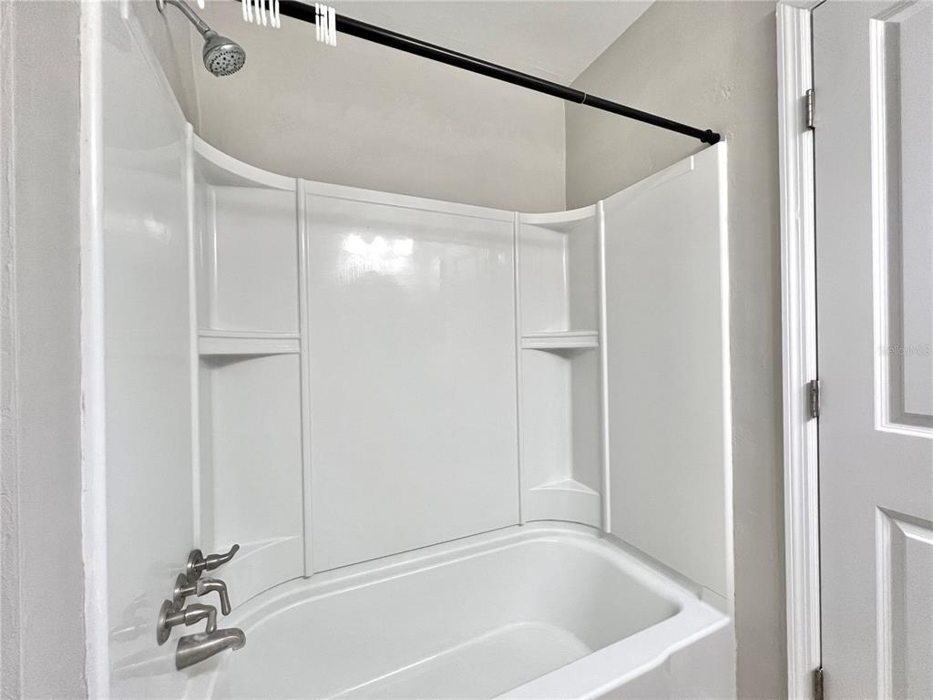 507 Northwest 39th Road, Unit 312 Gainesville, FL 32607 - Photo 23 of 34 a bathroom with a bathtub and a shower