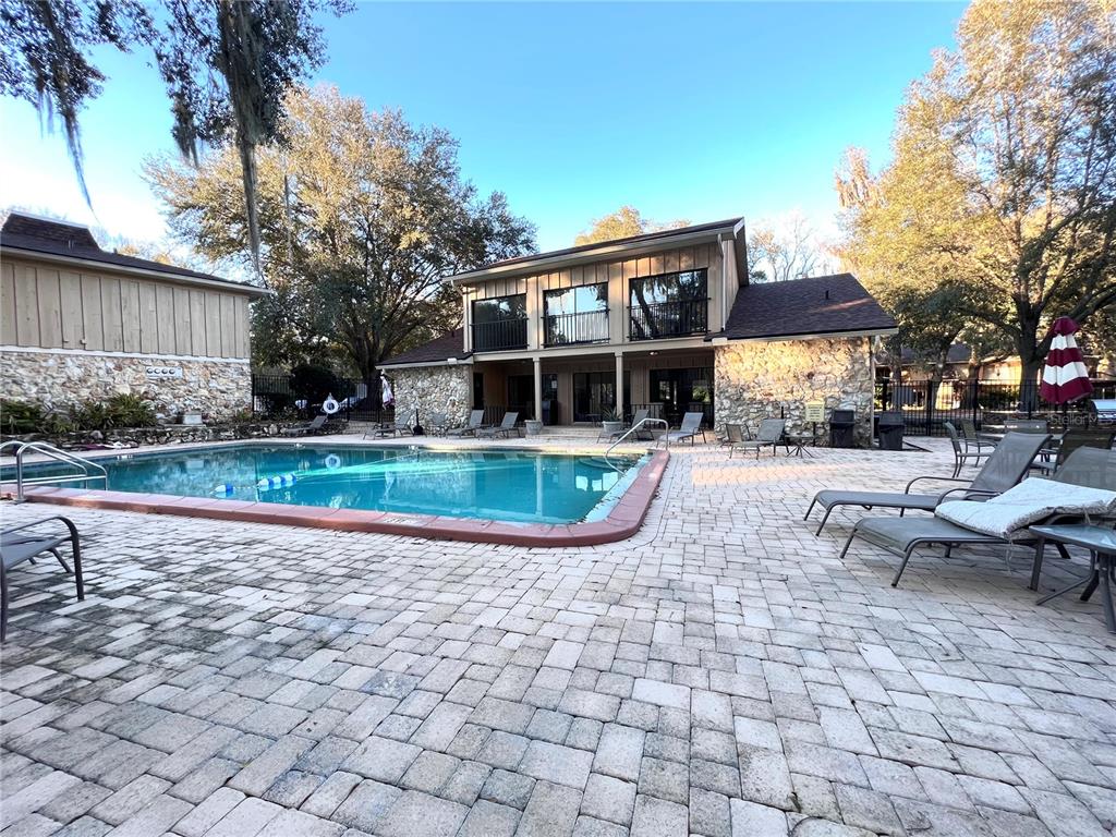 507 Northwest 39th Road, Unit 312 Gainesville, FL 32607 - Photo 33 of 34 a view of a house with backyard porch and sitting area