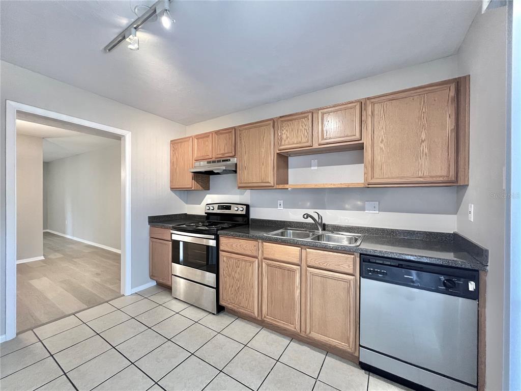 507 Northwest 39th Road, Unit 312 Gainesville, FL 32607 - Photo 7 of 34 a kitchen with cabinets appliances and a sink