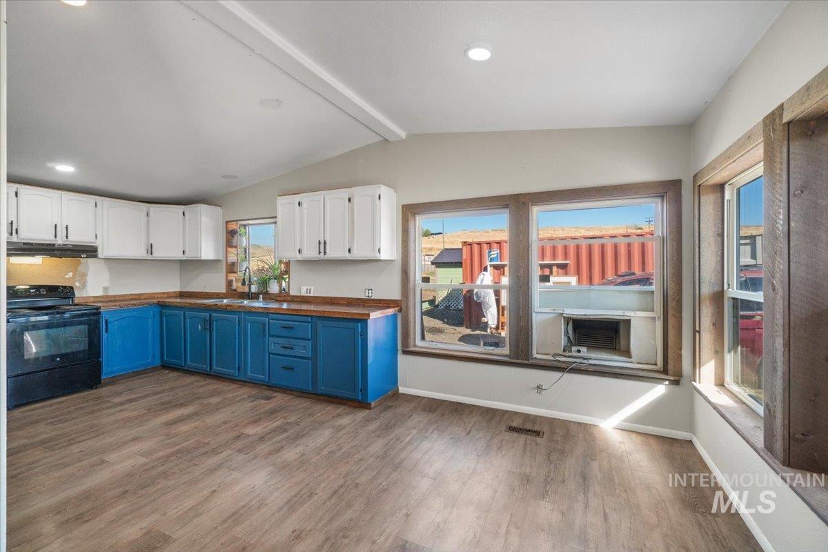 2284 Weiser River Road Weiser, ID 83672 - Photo 13 of 43 Kitchen with blue cabinetry, white cabinetry, electric range, dark wood-type flooring, and recessed lighting