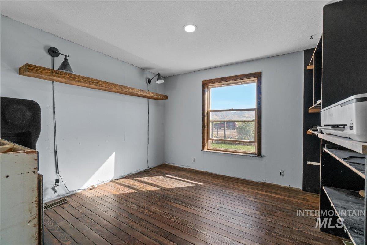 2284 Weiser River Road Weiser, ID 83672 - Photo 23 of 43 Unfurnished living room featuring dark wood-type flooring