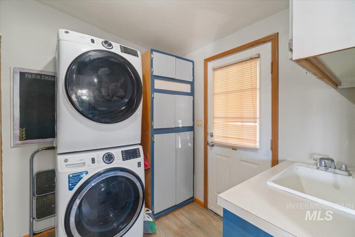 2284 Weiser River Road Weiser, ID 83672 - Photo 26 of 43 Washroom featuring light wood-type flooring and stacked washer and clothes dryer
