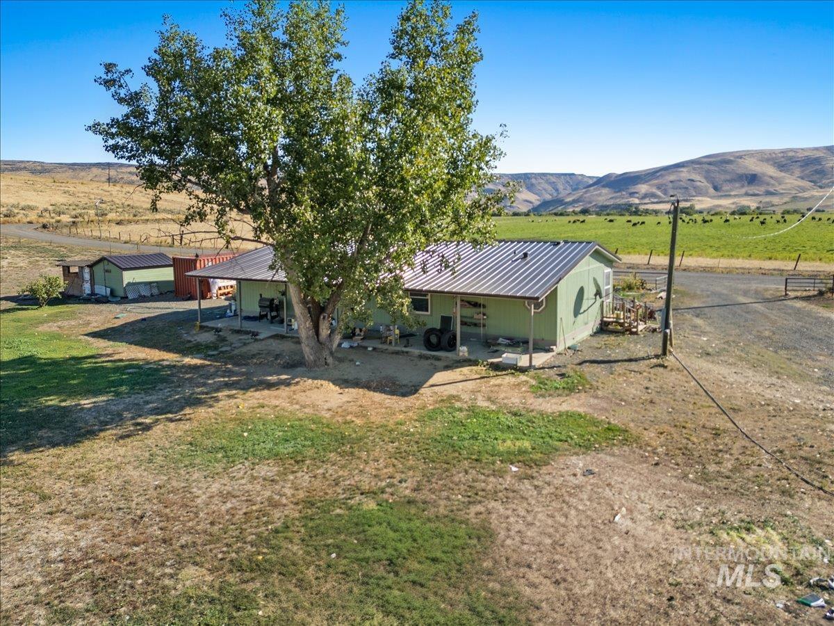 2284 Weiser River Road Weiser, ID 83672 - Photo 30 of 43 Rear view of house featuring a mountain view, a view of rural / pastoral area, a metal roof, and a patio