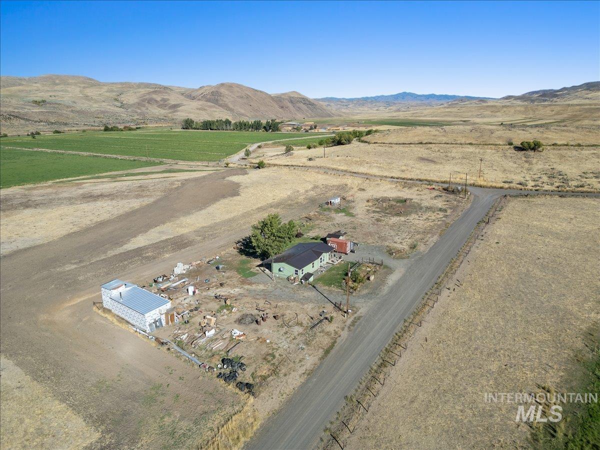 2284 Weiser River Road Weiser, ID 83672 - Photo 3 of 43 Aerial view of sparsely populated area featuring a mountainous background