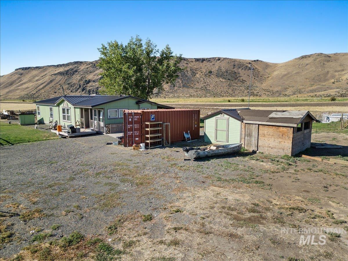 2284 Weiser River Road Weiser, ID 83672 - Photo 36 of 43 Back of house with a mountain view and a shed