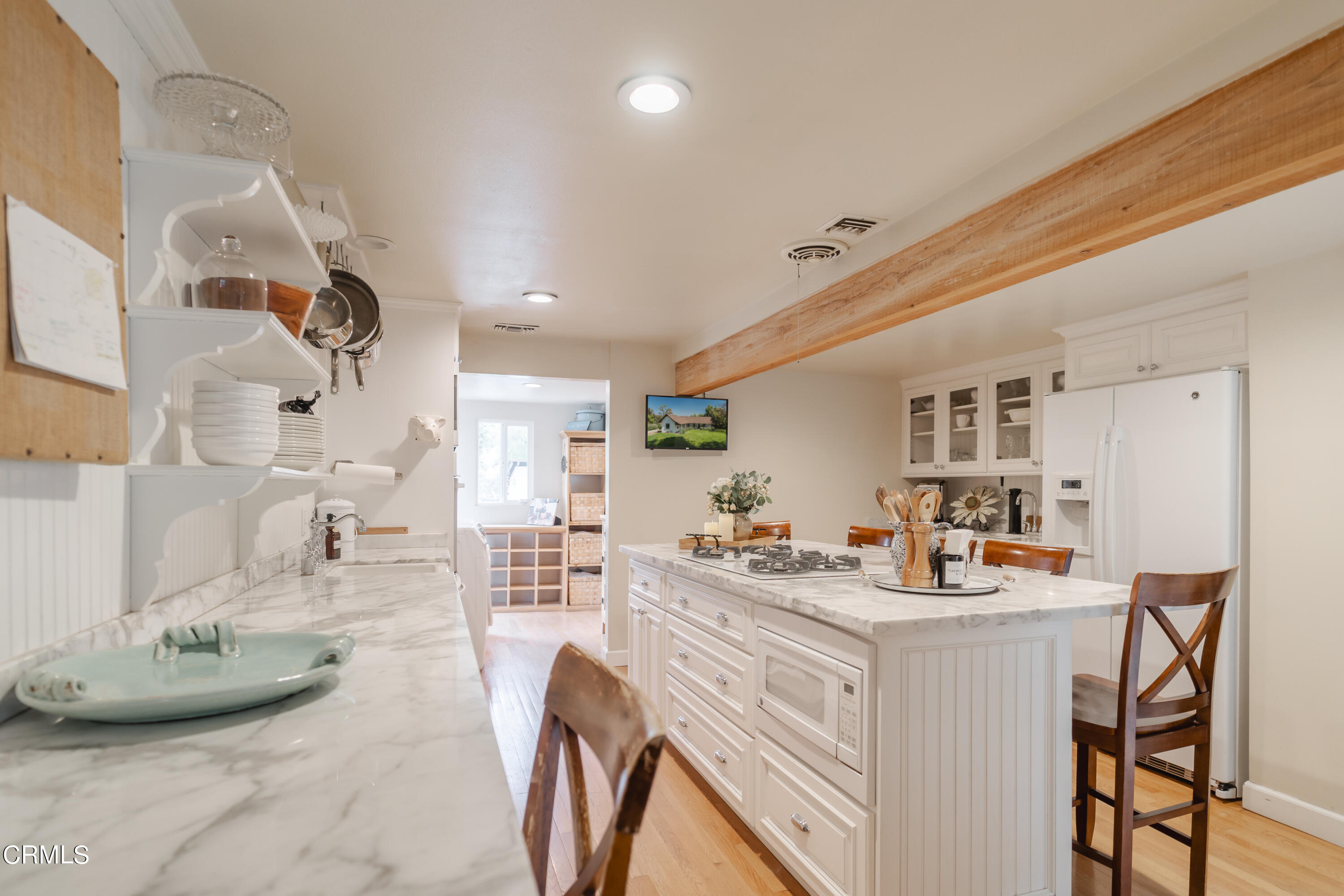919 Puddingstone Drive La Verne, CA 91750 - Photo 27 of 42 a room with stainless steel appliances kitchen island granite countertop a table chairs and a refrigerator