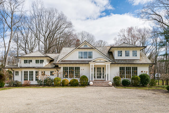 front view of a brick house with a yard