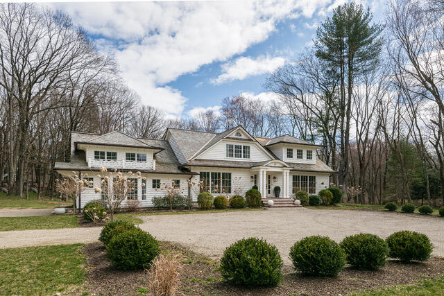 65 Mill Road New Canaan, CT 06840 - Photo 3 of 42 a front view of a house with a garden