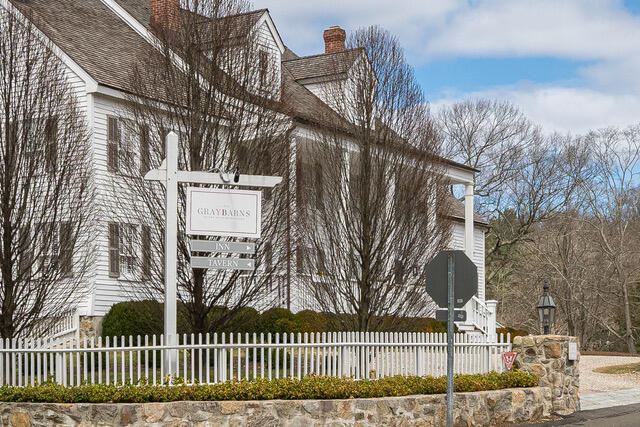 65 Mill Road New Canaan, CT 06840 - Photo 42 of 42 a view of a white house with a small yard and plants