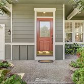 front view of a house with a yard and potted plants