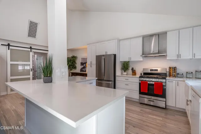 a kitchen with granite countertop a refrigerator and a stove
