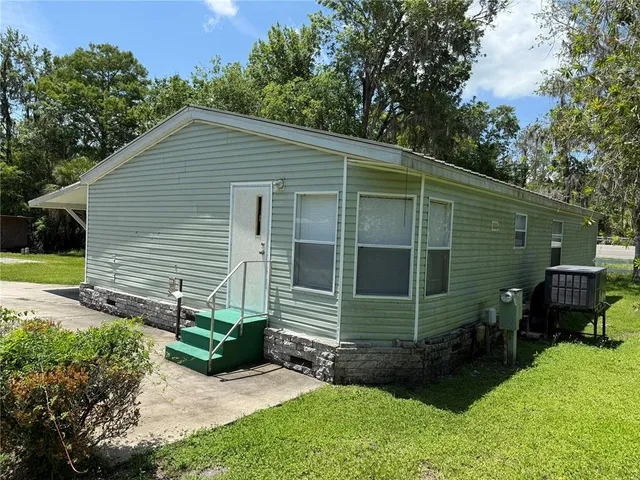 a side view of a house with a yard and garage