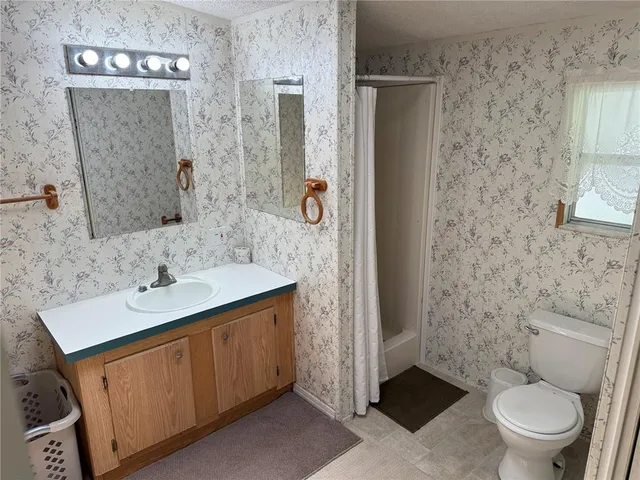 a bed sitting in a bedroom next to a bathroom