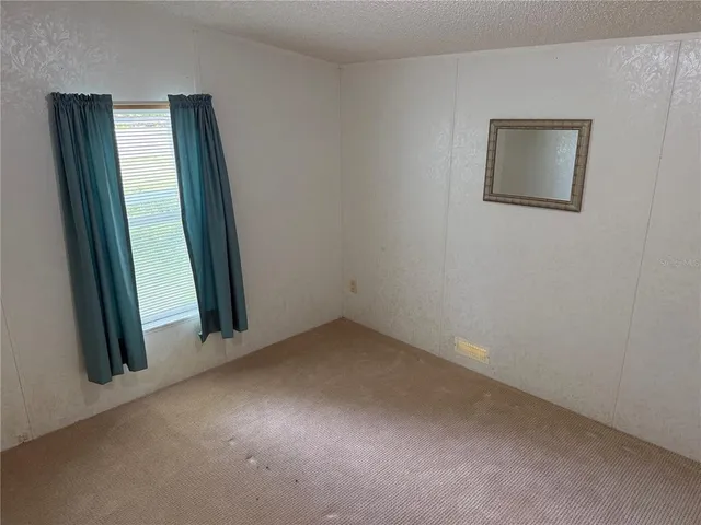 a backyard of a house with lots of green space and fountain