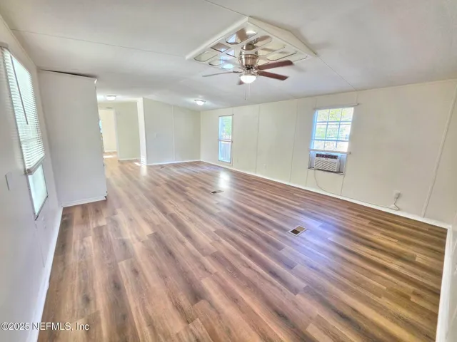 a living room with furniture kitchen and a chandelier
