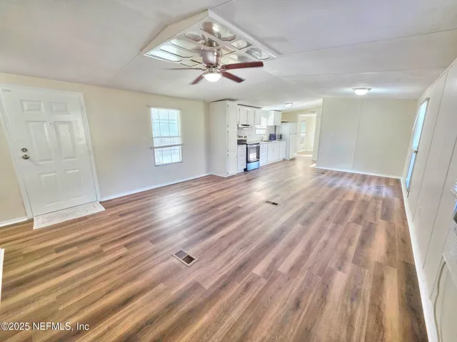 a kitchen with granite countertop a sink dishwasher stove and cabinets