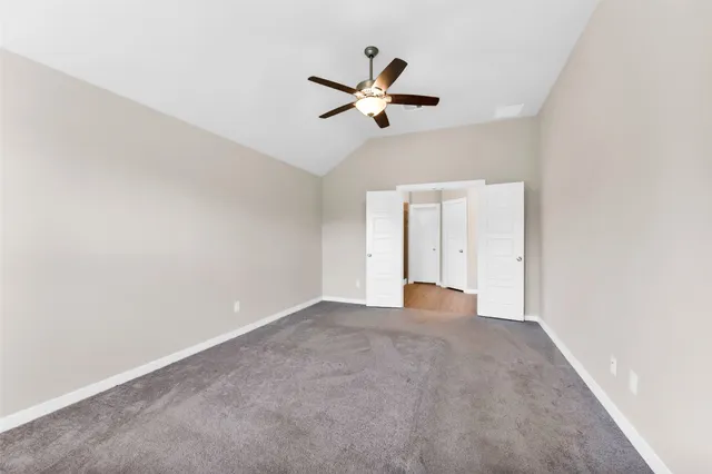 a view of empty room with ceiling fan