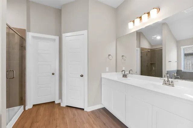 a bathroom with a double vanity sink and mirror